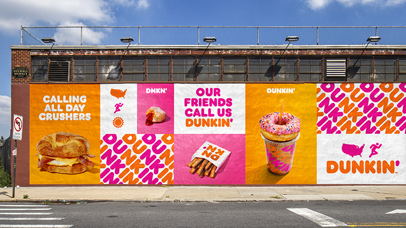 Vibrant Dunkin' branding displayed on the side of a building